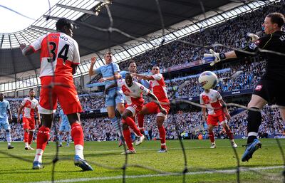 Edin Dzeko heads the late equaliser against QPR. Getty