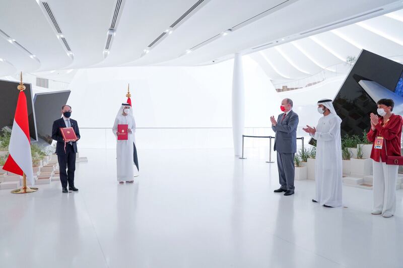 Sheikh Hamdan and Prince Albert applaud at a ceremony held during their visit.