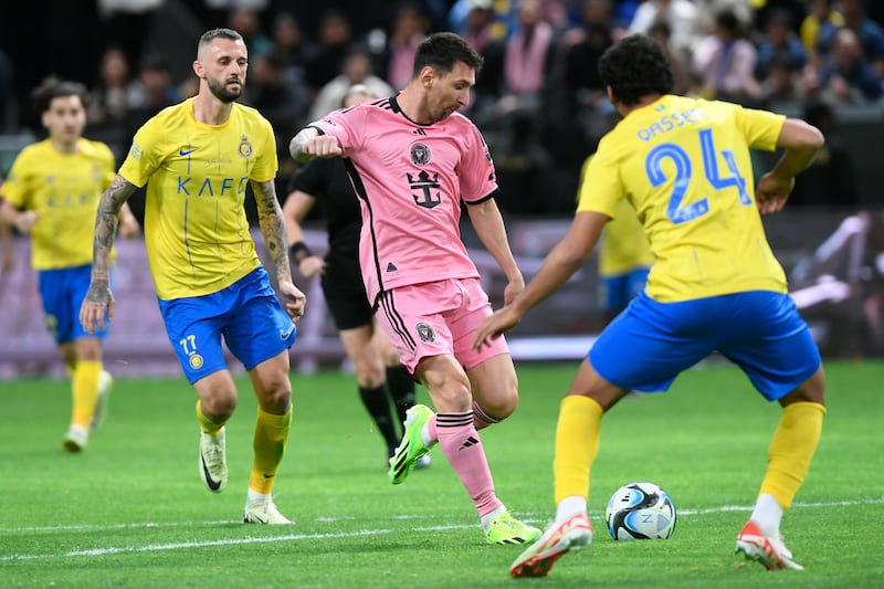 Lionel Messi of Inter Miami in action with Mohammed Qasem of Al Nassr. EPA