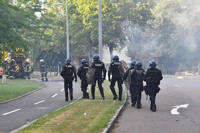 Gendarmes walk in a street in the Gresilles area of Dijon, eastern France, on June 15, 2020, as new tensions flared in the city after it was rocked by a weekend of unrest blamed on Chechens seeking vengeance for an assault on a teenager. Police sources said the unrest was sparked by an attack on a 16-year-old member of the Chechen community on June 10. Members of the Chechen diaspora then set out on so-called punishment raids seeking to avenge the assault, they said. After three successive nights of violence, early in the evening of June 15 some 150 people, some hooded and armed, again assembled in Dijon, setting rubbish bins and a car on fire.
 / AFP / Philippe DESMAZES
