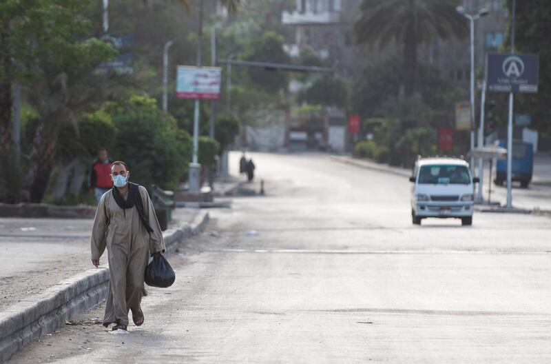 A man wearing a protective face mask walks in street in Cairo. EPA