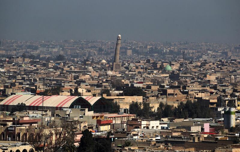 A general view shows the leaning minaret of the Great Mosque of al-Nuri in Mosul, on March 10, 2017, as Iraqi forces shell enemy positions during an offensive to retake the western parts of the city from the jihadists. (Photo by AHMAD AL-RUBAYE / AFP)