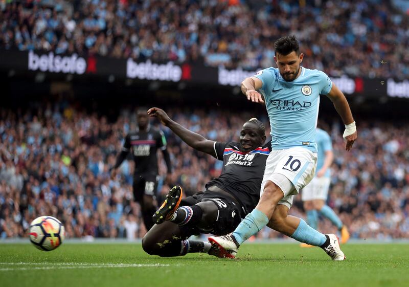 Manchester City striker Sergio Aguero, right, shoots under pressure from Crystal Palace's Mamadou Sakho. Nick Potts / PA