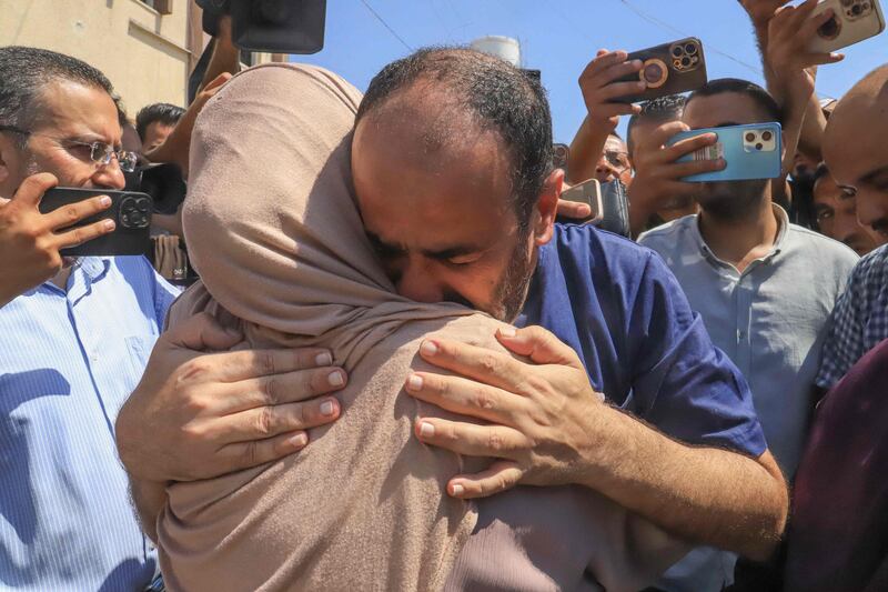 Al Shifa hospital director Mohammad Abu Salmiya is welcomed by relatives after his release from Israeli detention on Monday. Dr Abu Salmiya was accused of allowing the medical complex in Gaza city to be used by Hamas as an operations centre. AFP