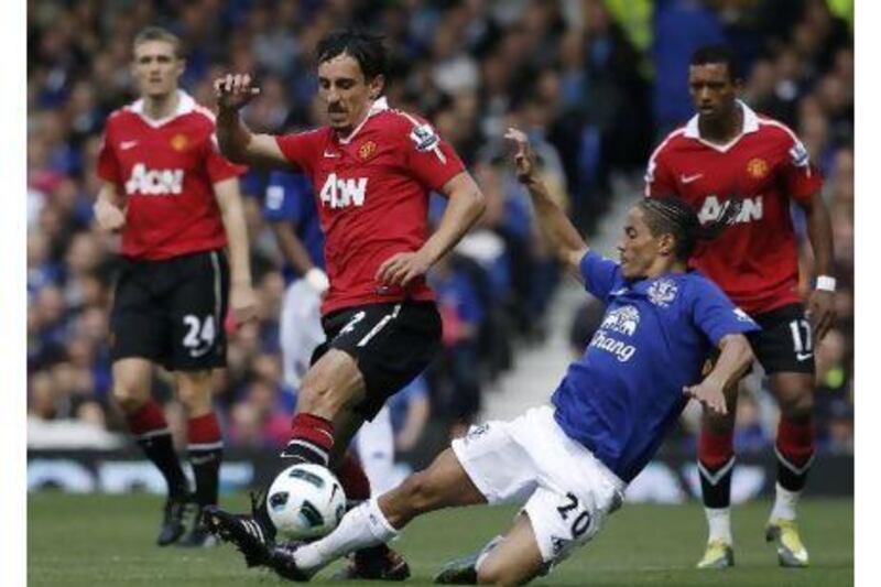 Gary Neville, in action above centre, was a popular player in the Manchester United dressing room with his teammates.