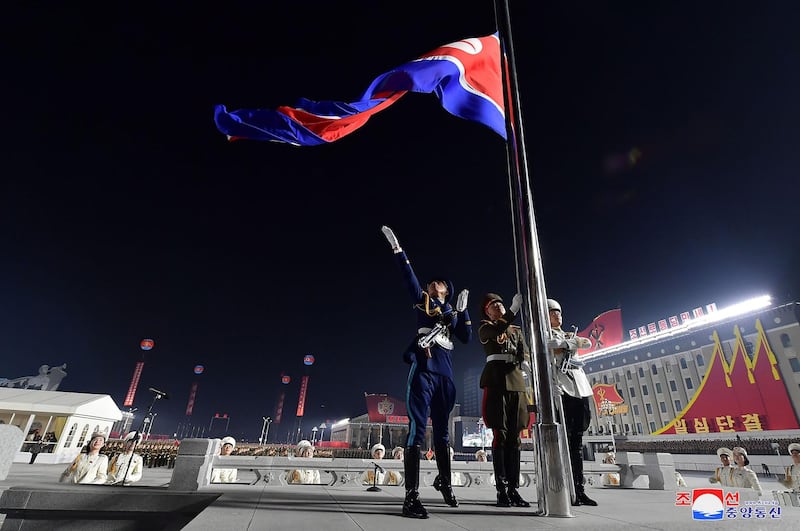 Soldiers raise their national flag during a military parade celebrating the 8th Congress of the Workers' Party of Korea (WPK) in Pyongyang. KCNA / AFP
