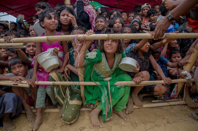 Rohingya Muslim children, who crossed over from Myanmar into Bangladesh, wait for their turn to receive food handouts distributed to children and women by a Turkish aid agency at Thaingkhali refugee camp, Bangladesh. Dar Yasin / AP Photo