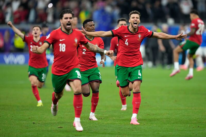 Portugal's players celebrate after winning on penalties. AP 