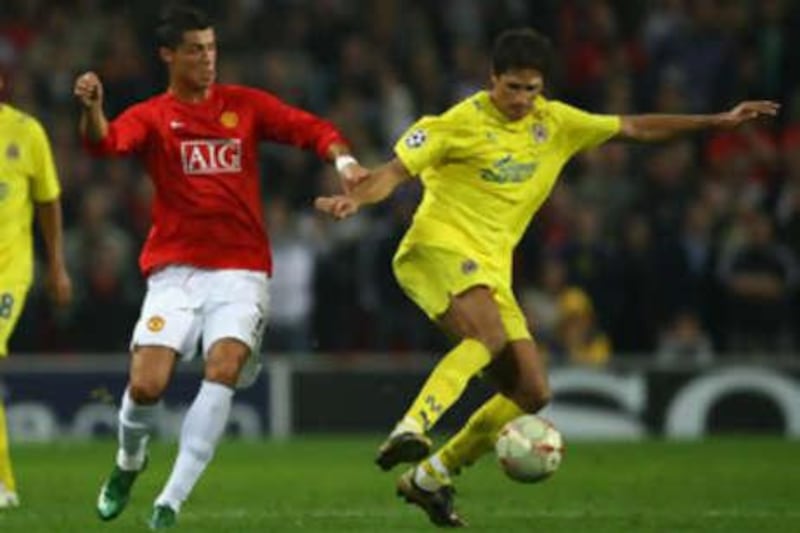 Edmilson of Villarreal, right, holds off the challenge of Cristiano Ronaldo of Manchester United at Old Trafford yesterday.