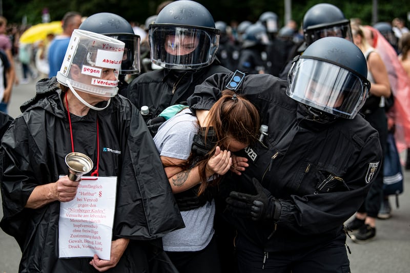 Police arrest a protester during a march against Covid-19 restrictions in Berlin. AP