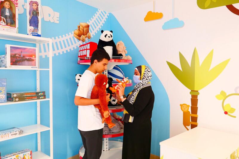 One of the kid at the toy shop at the Sanad village mall in Dubai Sustainable City on April 29,2021. This centre is for people of determination fit out with real simulation zones like malls, clinics and an airport to help students gain independence. Pawan Singh / The National. Story by Kelly