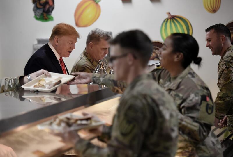 US President Donald Trump serves Thanksgiving dinner. AFP