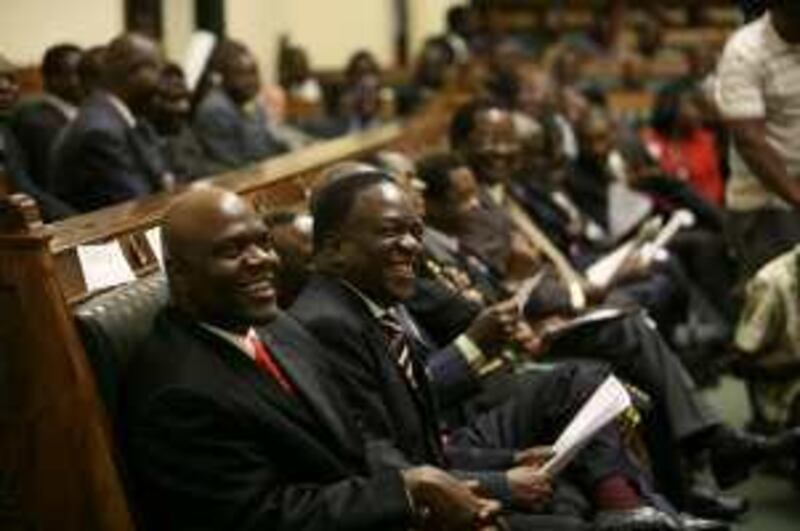  Zimbabwean members of parliament share a light moment as Morgan Tsvangirai (unseen)  takes the oath as Zimbabwe's new Prime Minister,  at the parliament in Harare, Zimbabwe, Tuesday, March 3, 2009.  He will deliver his first speech as prime minister Wednesday.  (AP Photo/Tsvangirayi Mukwazhi)