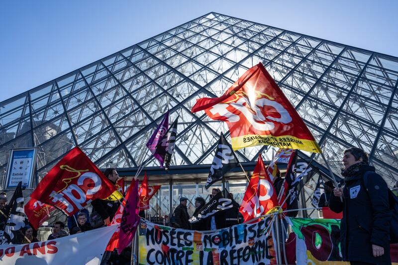 Striking union members form a picket line outside the Louvre in Paris on Monday. Getty Images