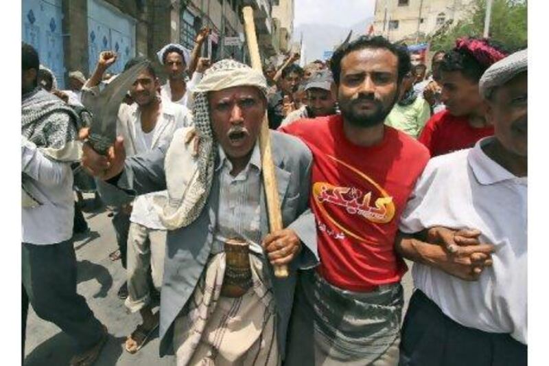 A protester brandishes his dagger during a demonstration calling for Ali Abdullah Saleh to quit in Taiz on Saturday. Anees Mahyoub / AP Photo
