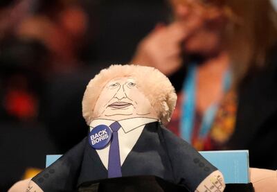 A muppet toy depicting Britain's Prime Minister Boris Johnson sits on a chair at the Conservative Party Conference in Manchester, England, Sunday, Sept. 29, 2019.  The ruling Conservative Party is committed to Britain's Brexit split from the European Union leaving on the scheduled date of Oct. 31.(AP Photo/Frank Augstein)