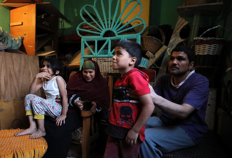 Married couple Heba Mahmoud and Samri Ragab, who are both visually impaired, sit with their children in the living room of their home in Cairo.  Reuters