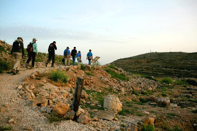 Members of the Associates for Biblical Research, march towars their excevaiton sight, during the early hours of the morning, near Shilo, West Bank.