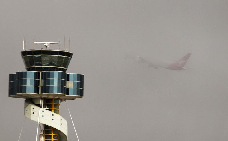 A Qantas plane takes off from Sydney airport amid thick fog in 2013. Pilots have called for better co-ordination during inclement weather conditions. Daniel Munoz / Reuters