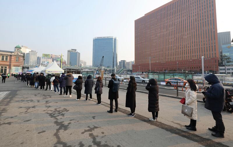People queue for coronavirus tests in Seoul on February 26, as South Korea grapples with a surge in infections driven by the Omicron variant. Yonhap via AP
