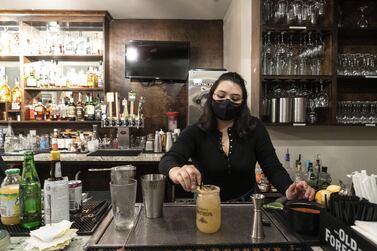 A masked bartender works at a restaurant in Houston, Texas, on Wednesday, March 10, 2021. Bloomberg