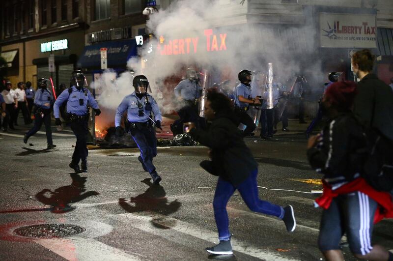Police charge at a crowd along 52nd Street in West Philadelphia in the early hours of Tuesday. AP AP