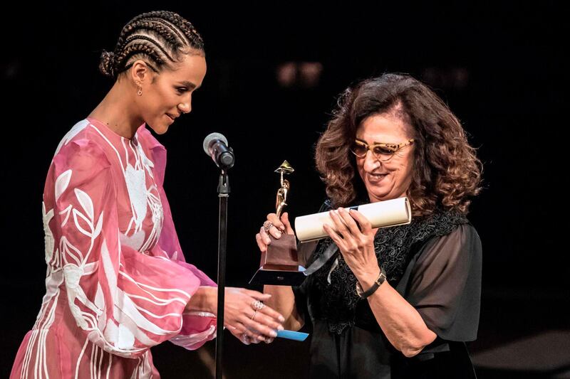 Egyptian producer Marianne Khoury receives the Audience Award from Nathalie Emmanuel during the closing ceremony of the 41st Cairo International Film Festival. AFP