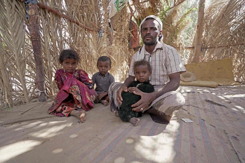 Yehya Hayba and his children, who fled fighting between Huthi rebels and the Saudi-backed government forces, stay at the al-Sumya camp for internally displaced persons (IDP) east of Marib city, the last remaining government stronghold in northern Yemen, on November 24, 2021.  - Al-Sumya, with its clusters of makeshift tents, has witnessed an influx of displaced people, with hundreds arriving in a month, according to the International Organization for Migration.  The camp, with scant resources, bears testament to a conflict that has forced millions from their homes, creating what the United Nations calls the world's worst humanitarian crisis.  (Photo by AFP)