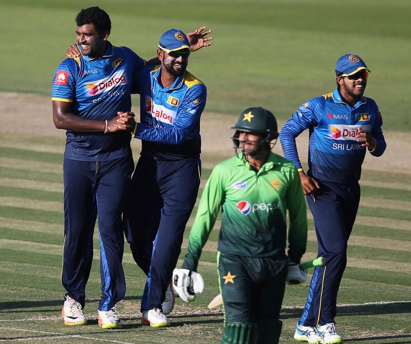 Sri Lanka's bowler Thisara Perera, 1st left, celebrates with his team-mates dismissal of Pakistan's Shoaib Malik during their second ODI cricket match in Abu Dhabi, United Arab Emirates, Monday, Oct. 16, 2017. (AP Photo/Kamran Jebreili)