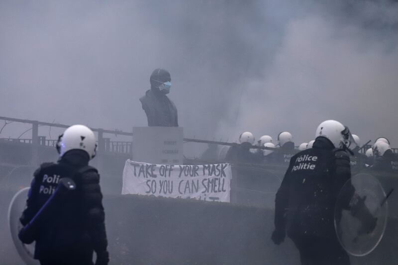 A police line near a statue of Robert Schuman, first president of the European Parliament, during the European Demonstration for Democracy protest. Bloomberg