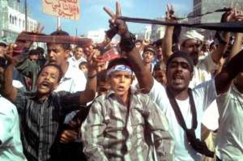 Yemenis shout slogans during an anti-government protest in the Al-Habilain town of Lahj province, 320 kms south of Sanaa, on December 19, 2009 against an air strike that targeted an Al-Qaeda camp. An exiled southern leader accused on December 18 the Yemeni authorities of having killed more than 60 civilians in the air strikes Sanaa said targeted an Al-Qaeda training camp in the Abyan region. AFP PHOTO/STR *** Local Caption ***  483685-01-08.jpg