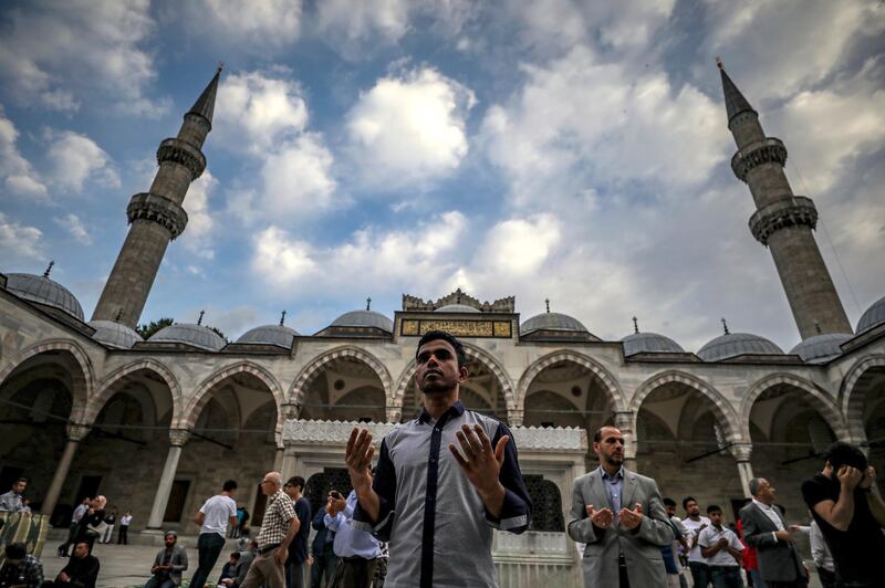 Turkey's Muslims pray during the first day of Eid Al Fitr, which marks the end of the holy fasting month of Ramadan at the Suleymaniye Mosque in Istanbul. AP Photo