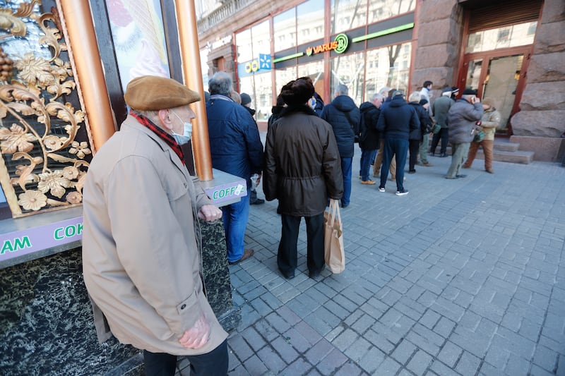 People queue outside a grocery store in the Ukrainian capital. EPA