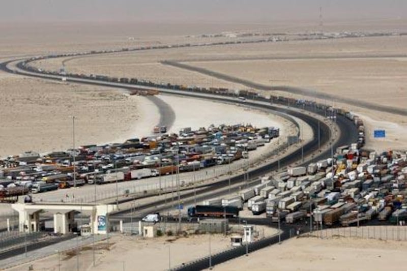 Transport trucks wait in line at the UAE / Saudi Arabia border crossing.