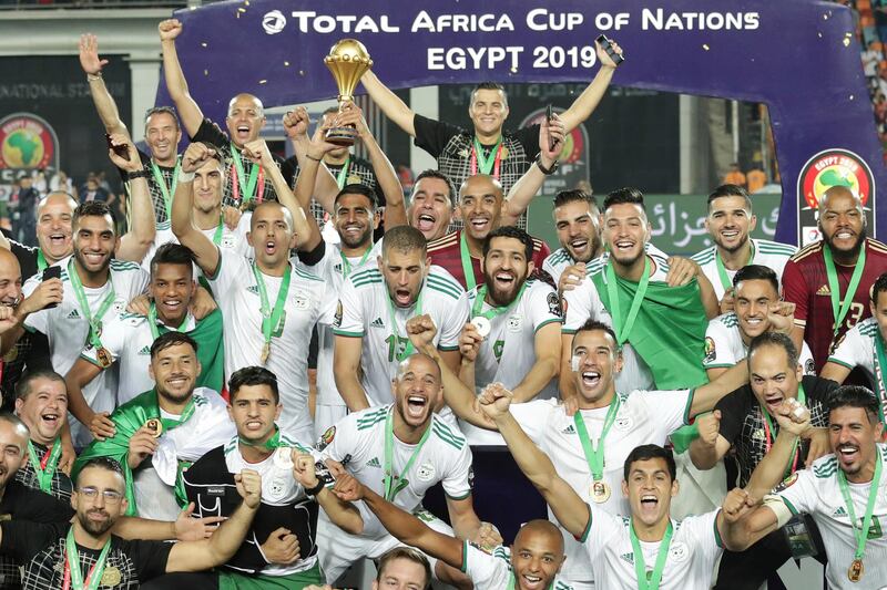 Algeria's captain Riyad Mahrez, centre, holds up the Africa Cup of Nations trophy after Algeria defeated Senegal 1-0 in the final in Cairo on Friday, July 19, 2019. AP