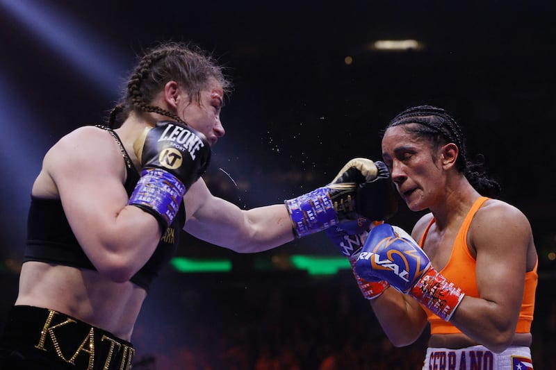 Katie Taylor connects with a left punch on Amanda Serrano. AFP