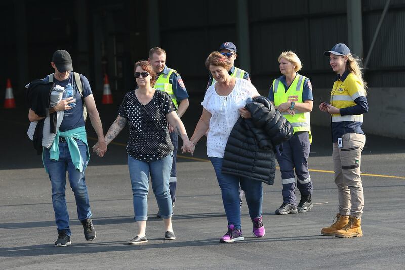 Evacuees from Mallacoota arrive aboard the navy ship MV Sycamore at the port of Hastings, Australia. Getty