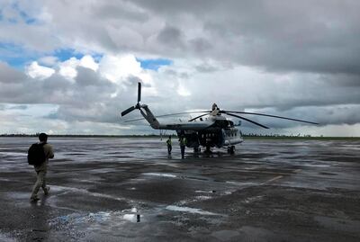 A UN humanitarian helicopter prepares for a day of work, at the airport in the Mozambique city of Beira, Friday March 22 2019.  Some hundreds of people are dead, many more still missing and with many thousands at risk from massive flooding in Mozambique, Malawi and Zimbabwe caused by Cyclone Idai. (AP Photo/Cara Anna)