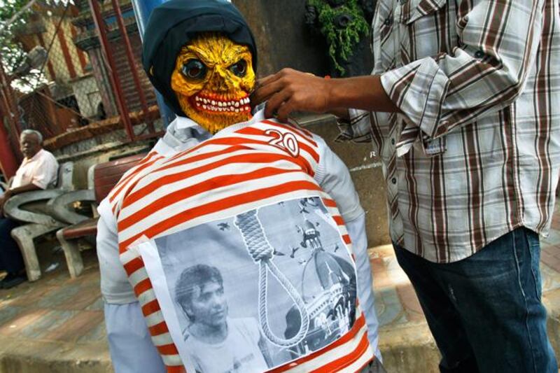 An activist of Akhil Bharatiya Vidyarthi Parishad or All Indian Student Council, prepares an effigy of Mohammed Ajmal Kasab, the lone surviving gunman from the 2008 terror attacks on Mumbai, before it was burned to celebrate his execution in Bangalore, India, Wednesday, Nov. 21, 2012. Kasab, a Pakistani citizen, was one of 10 gunmen who rampaged through the streets of India's financial capital for three days in November 2008, killing 166 people.  (AP Photo/Aijaz Rahi)