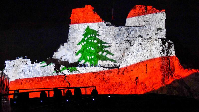 The Lebanese flag is projected on the medieval Beaufort Castle, known in Arabic as Al-Shaqif Citadel, near the southern Lebanese town of Arnoun in the Nabatiyeh district, on July 26, 2018, during a concert by Lebanese-Armenian musician, composer and pianist Guy Manoukian. (Photo by Ali DIA / AFP)