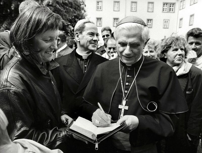 Cardinal Joseph Ratzinger in 1994 signing an autograph during the 1,240th anniversary of the city of Fulda, Germany. AFP