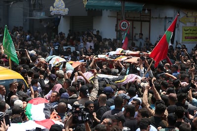 Palestinians attend a funeral ceremony after 13 people, including children, were killed in Israeli air strikes on Gaza city. Nagham Mohanna for The National