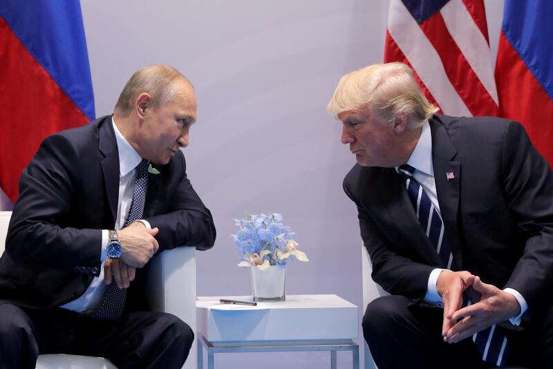FILE PHOTO: Russia's President Vladimir Putin talks to U.S. President Donald Trump during their bilateral meeting at the G20 summit in Hamburg, Germany, July 7, 2017.  REUTERS/Carlos Barria/File Photo