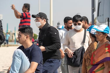 DUBAI, UNITED ARAB EMIRATES. 29 JANUARY 2020. Tourists and sightseers wear facial masks on Sunset Beach next to the Burj Al Arab and Jumeirah Beach Hotel. (Photo: Antonie Robertson/The National) Journalist: Standalone. Section: National.