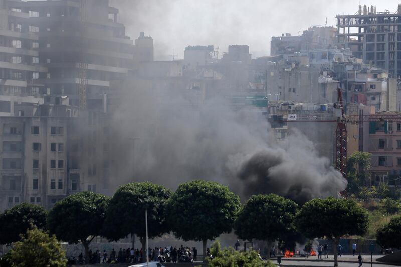 Black smoke rise from burning tires that were set fire to block a road during a protest against government's plans to impose new taxes in Beirut, Lebanon, Saturday, Oct. 19, 2019. The blaze of protests was unleashed a day earlier when the government announced a slate of new proposed taxes, including a $6 monthly fee for using Whatsapp voice calls. The measures set a spark to long-smoldering anger against top leaders from the president and prime minister to the numerous factional figures many blame for decades of corruption and mismanagement. (AP Photo/Hassan Ammar)