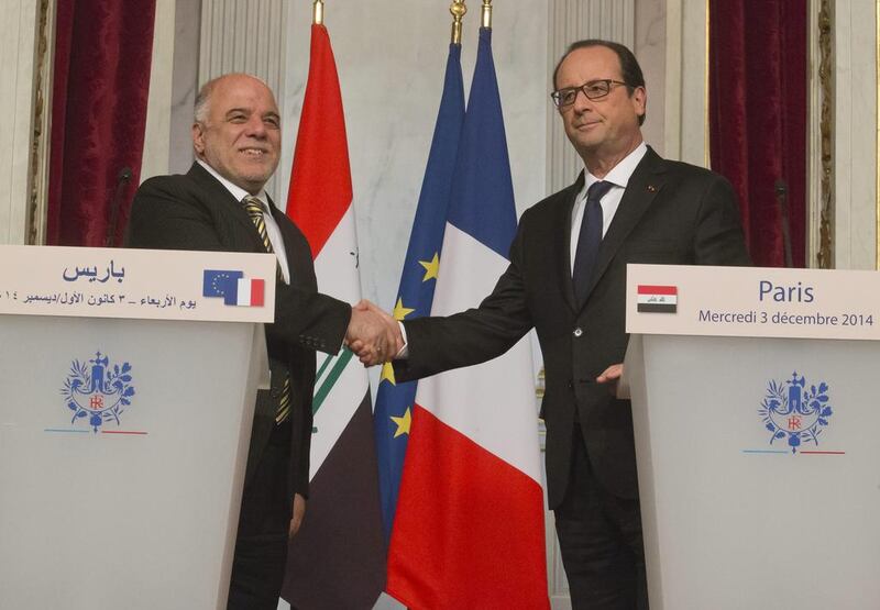 Iraqi Prime Minister Haider Al Abadi, left, and France's President Francois Hollande, right, shake hands after a joint media conference at the Elysee Palace in Paris, Wednesday, December 3, 2014. France have launched a major air assault on ISIL militants in Iraq. Michel Euler / AP Photo