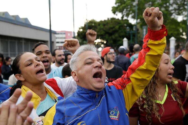 Supporters of Venezuela's President Nicolas Maduro cheer outside the polling station where his is voting during presidential elections in Caracas, Venezuela. Ricardo Mazalan / AP Photo