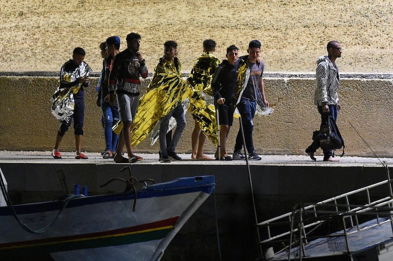 Migrants disembark in the Sicilian island of Lampedusa, Italy, June 21, 2019. Picture taken June 21, 2019. REUTERS/Guglielmo Mangiapane