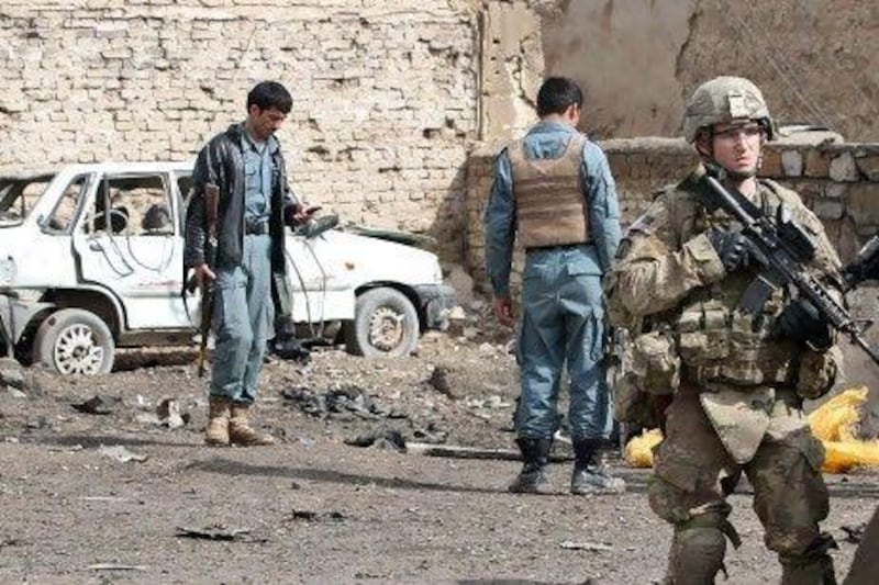 International and Afghanistan security forces patrol after a suicide bomber killed a policeman in the southern Afghan city of Kandahar on Monday.