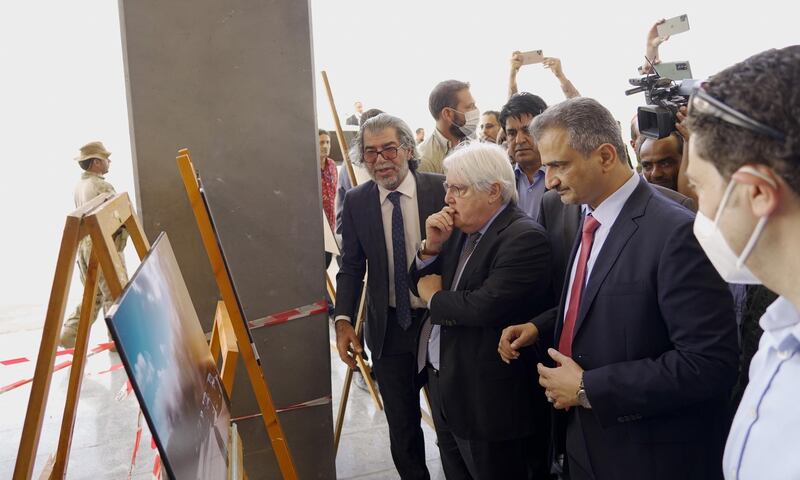 UN Special Envoy for Yemen Martin Griffiths and Aden's governor Ahmed Hamed Lamlas look at photograph depicting last week's attack during an exhibition held at Aden airport, in Aden, Yemen. EPA